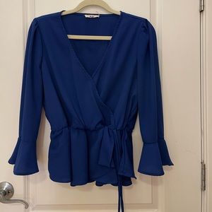 Blue cross over blouse with a tie